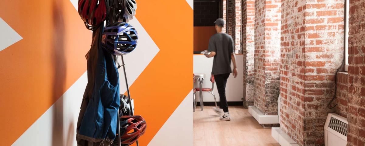 Entrance to Message Agency's office depicting a wall mural with the logo, brick wall, and bicycle helmet