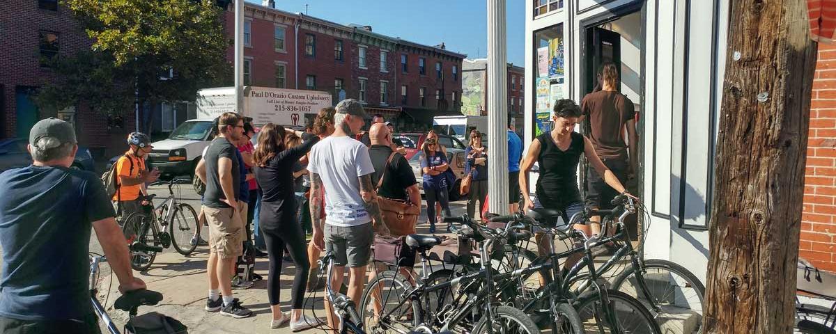 Participants in the Gearing Up bike tour standing with their bikes ready to begin the ride